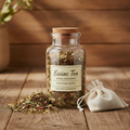 Essiac Tea herbal blend in a glass jar on a natural wooden background